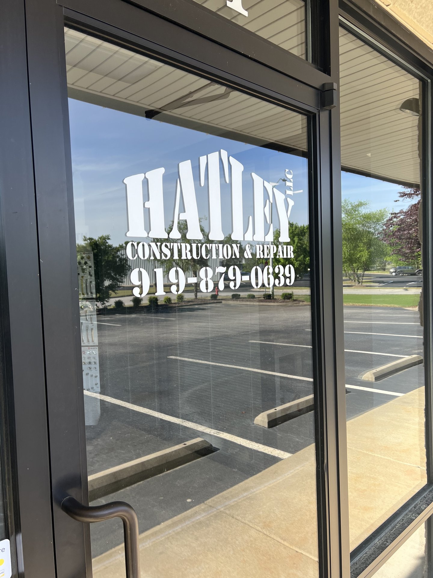 Hatley Construction front door with logo and phone number