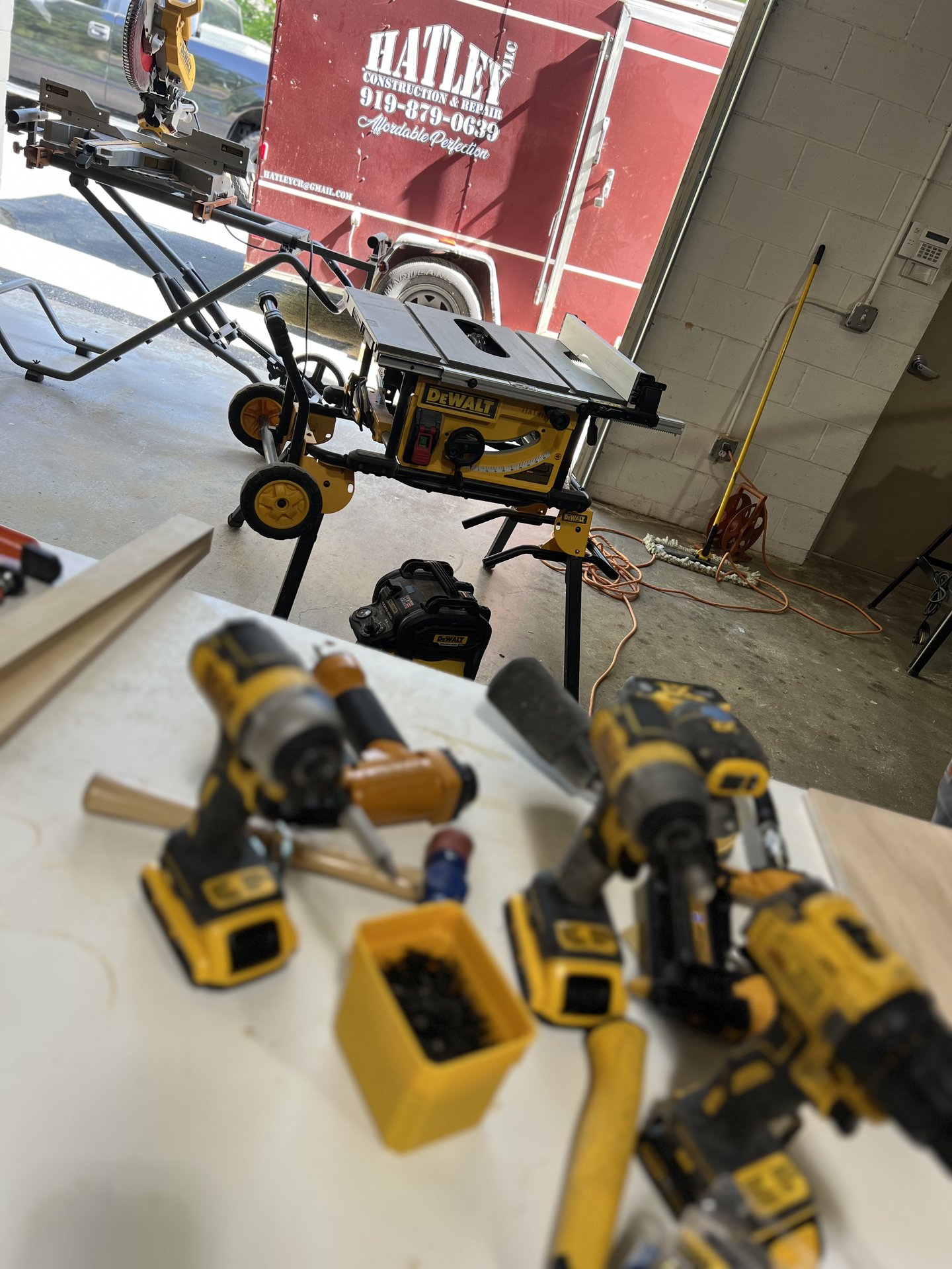 DeWalt tools and hand jigs on the workbench - manufacturing cabinetry by hand before CNC
