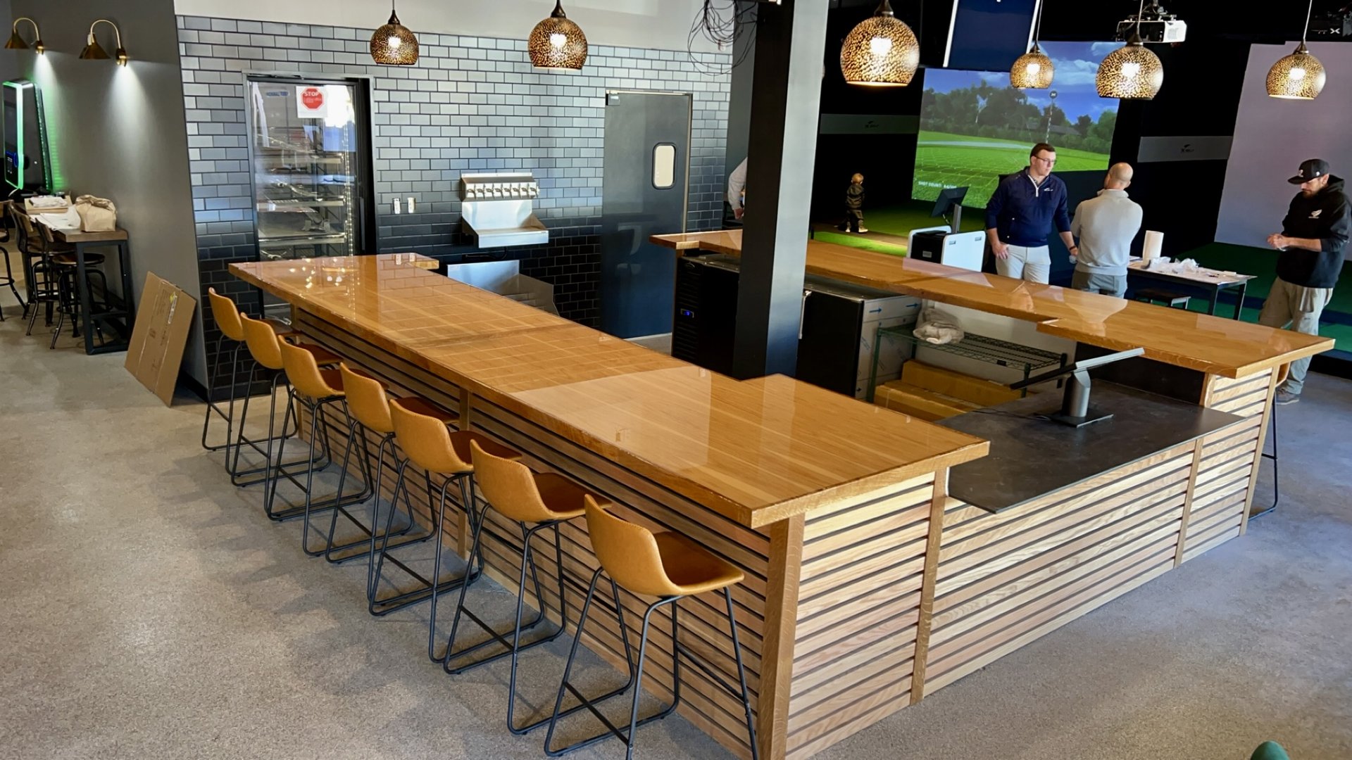 Restaurant bar with butcherblock countertop and slatted panel front built by Hatley Construction