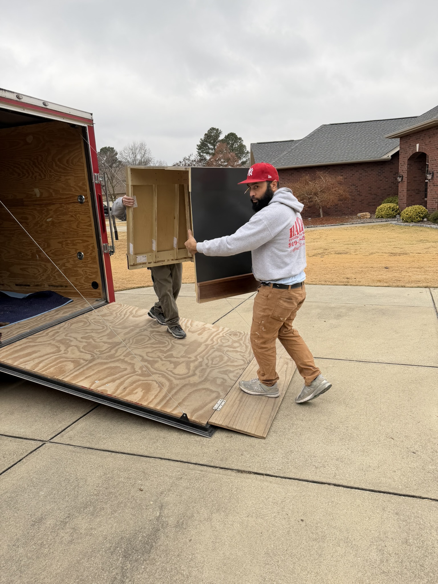 Hatley crew unloading cabinets from the trailer on delivery day