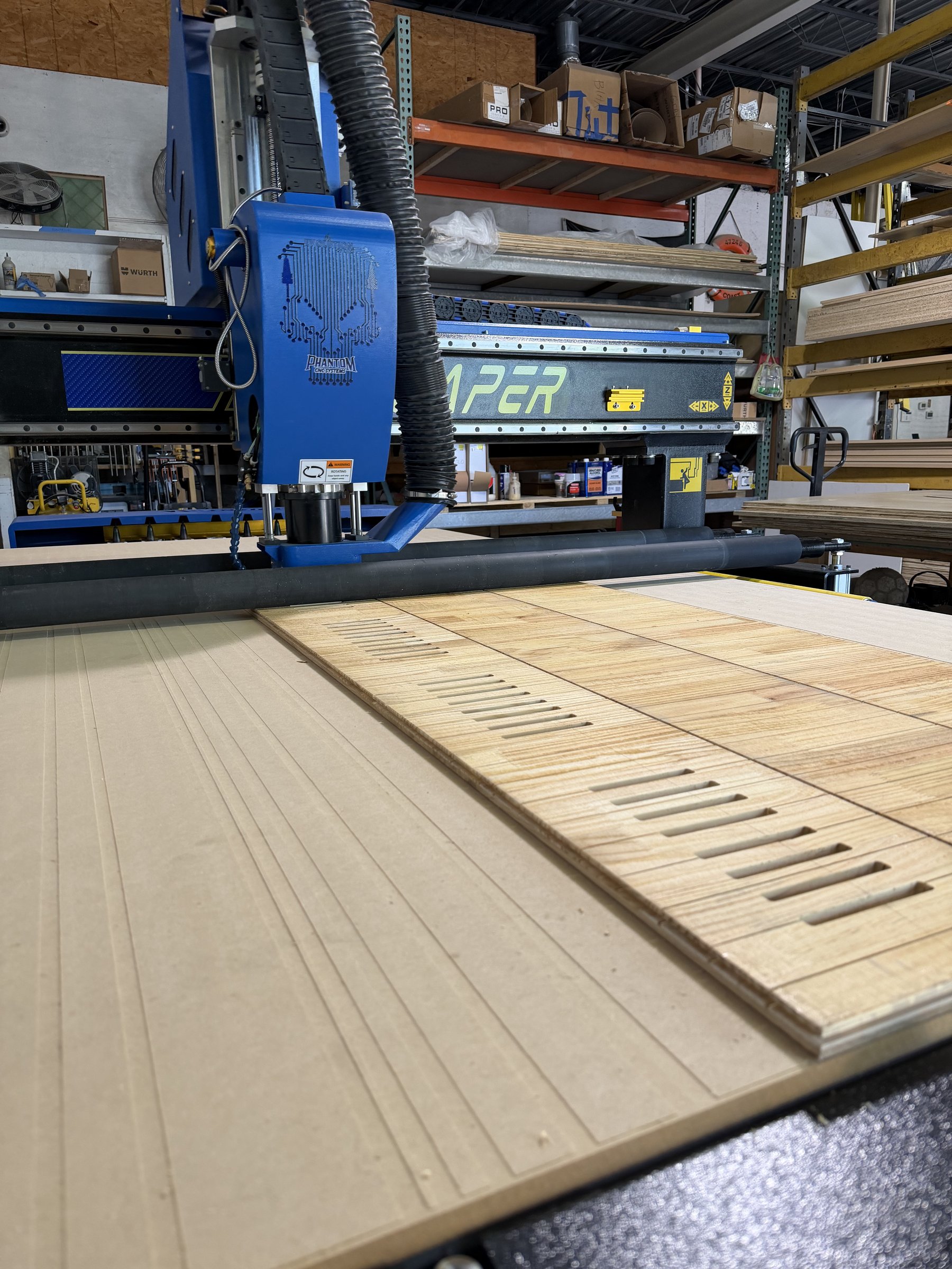 CNC router cutting cabinet panels in Hatley shop
