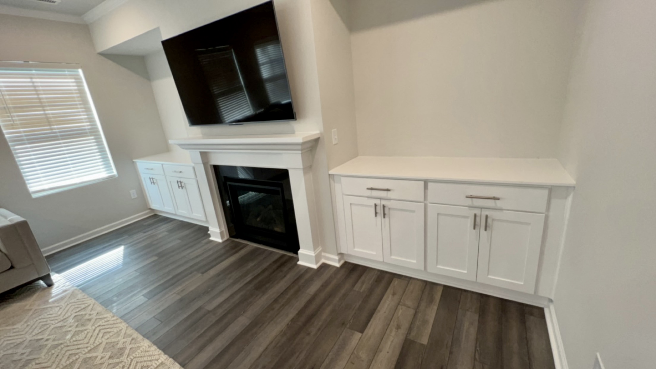 Custom built-ins flanking fireplace with TV